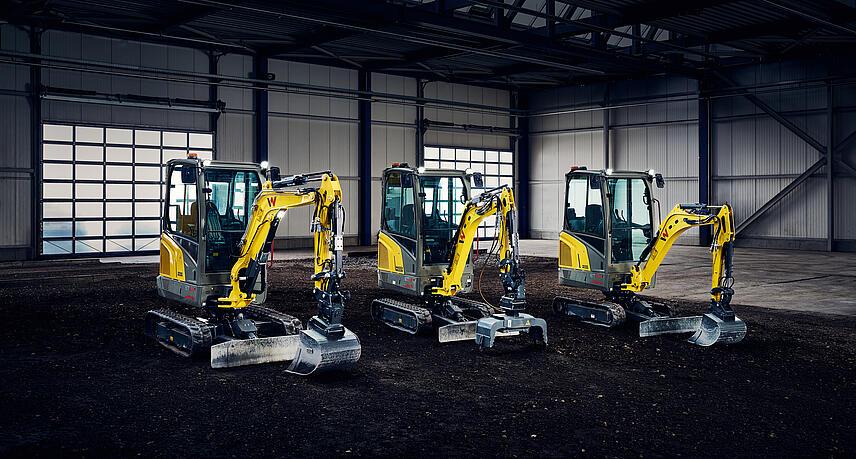Mini-excavators standing in big hall