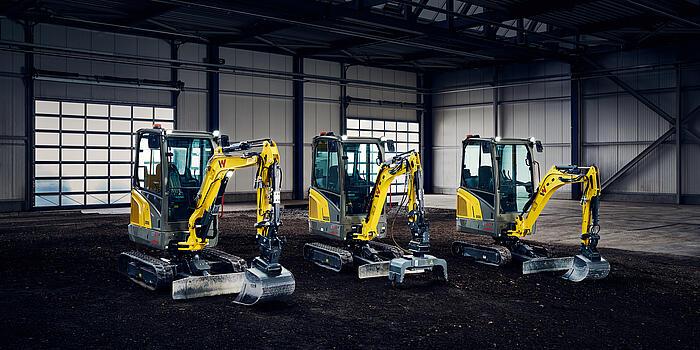 Mini-excavators standing in big hall