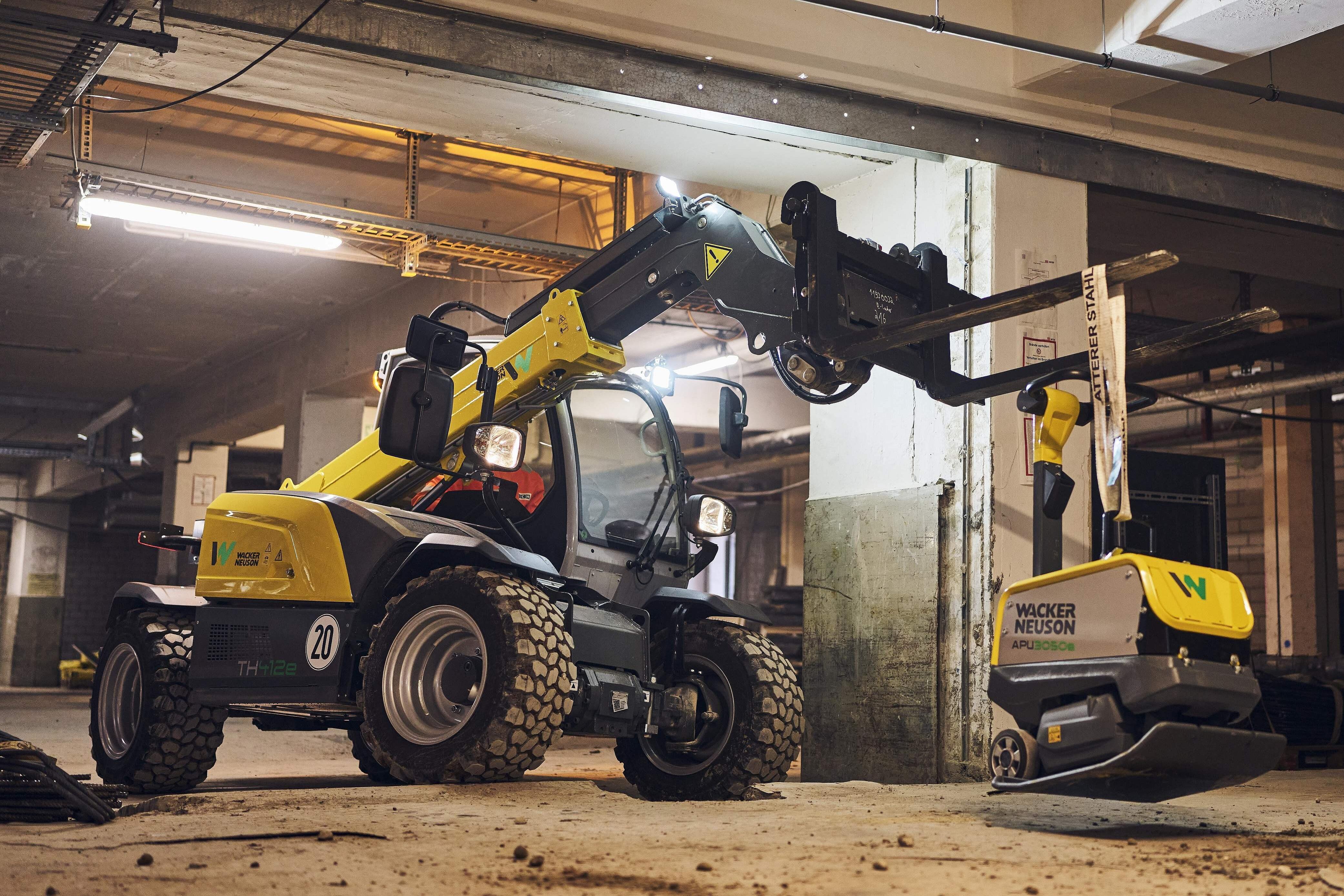 Electric telehandler with electric vibratory plate in action