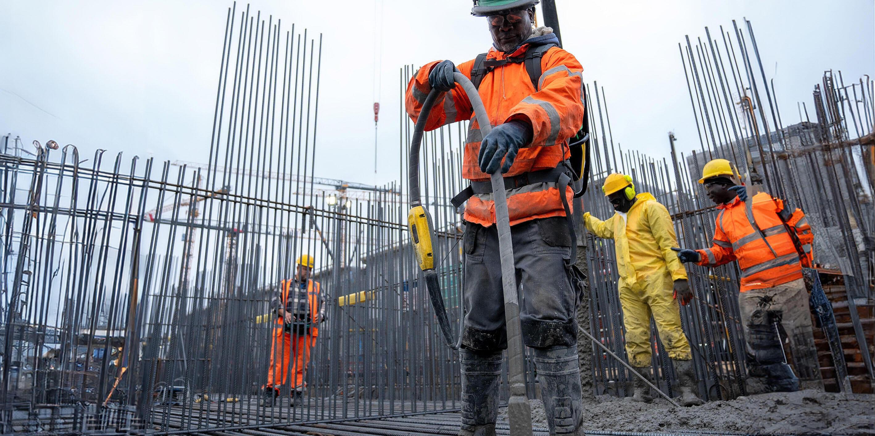 one worker consolidating concrete